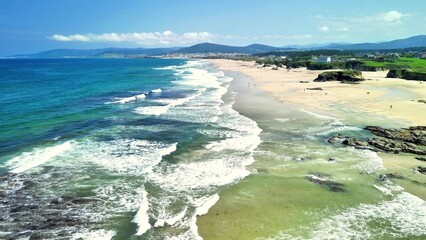 A Stunning Aerial View of the Serene Beach with Gentle Waves and a Beautiful Shoreline Stretch