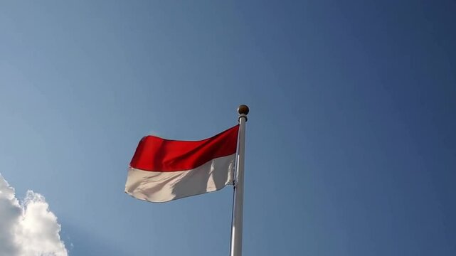 Indonesia flag with a red and white stripe is flying in the sky