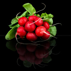 Red radishes on dark plate