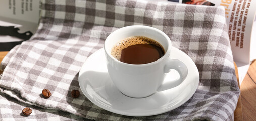 Cup of hot espresso on table, closeup