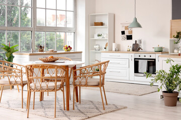 Interior of kitchen with dining table, counters and houseplants