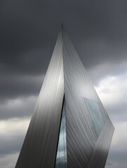 Architectural marvel Close up of a modern building's geometric facade against a dramatic sky.