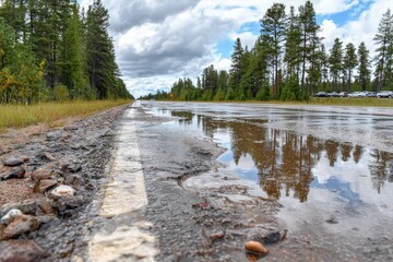 Reflecting Sky Through Puddles on a Rural Road