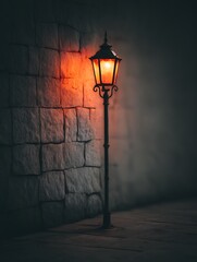 Illuminated Street Lamp Against a Stone Wall at Night. A solitary lamp casts a warm glow on a dark, textured stone wall, creating a moody and atmospheric scene.