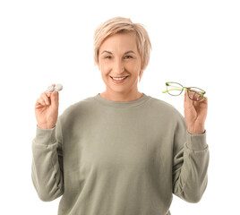Mature woman with contact lens case and eyeglasses on white background