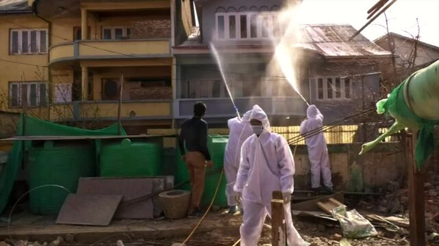 Houses Kit wearing frontline warriors sanitising streets houses and parts of srinagar city. SMC Srinagar is doing good fumigation in covid-19 time.