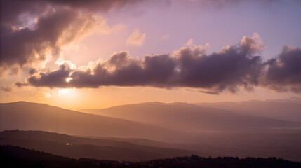 Fototapeta premium Golden sunset over a serene landscape, warm light through clouds, orange and purple hues blending in harmony
