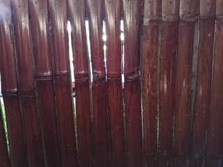 Weathered Brown Bamboo Fence with Vertical Slats