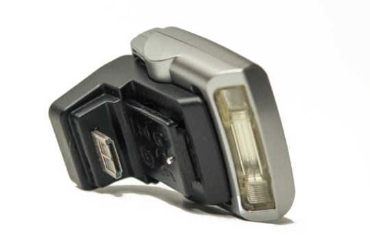 close up Mirrorless camera external flash on a white background.