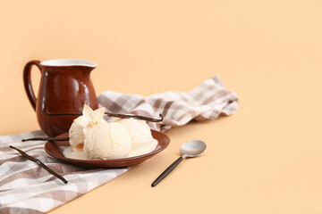 Plate with scoop of vanilla ice cream and jug on beige background
