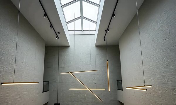 Modern architectural interior featuring minimalist lighting design in a spacious atrium with natural light