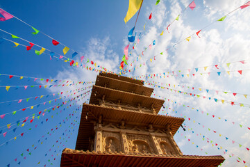 Chinses wood tower architecture with colorful flags