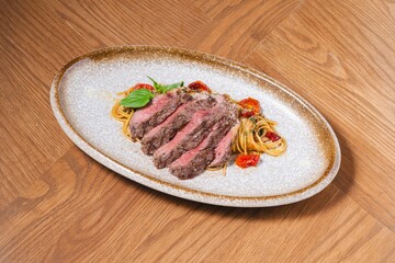 Grilled Beef Steak with Spaghetti Pasta on Rustic Plate