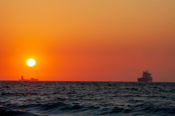 Sunset ship running on ocean with oversea shipment business 