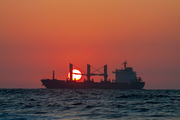 Sunset ship running on ocean with oversea shipment business 