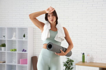 Tired young woman after  training in gym