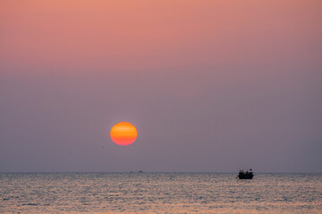 Sunset and boat in the ocean