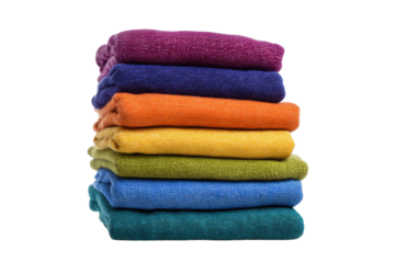 Stacked colorful towels in rainbow order on black background, cut out