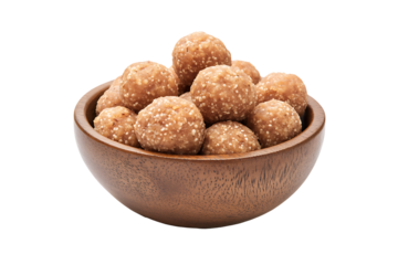 Traditional indian tilgul laddu or sesame peanut balls in a wooden bowl, perfect for festive sweets and cultural food themes, isolated on transparent background