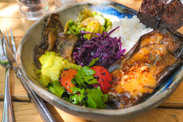 Delicious bowl of vibrant food featuring rice and vegetables