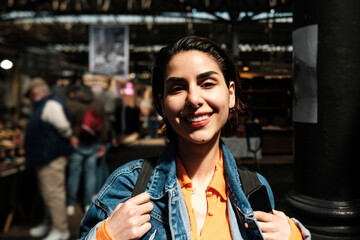 Young woman smiling in street market in london