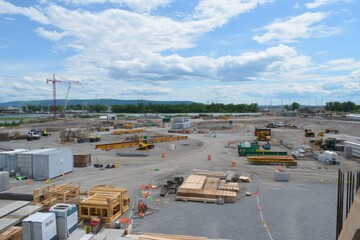 Fototapeta premium Construction Site Overview with Equipment and Materials in Progress