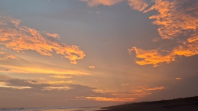 Golden Sky at Dusk on Exotic Black Sand Beach, Sunset Light Caressing the Calm Ocean, Orange Reflections on the Water Surface Soothing the Eyes, Natural and Romantic Tropical Atmosphere