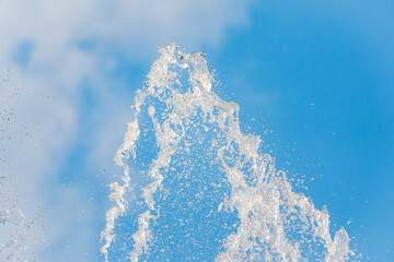 Splashes and jets of water against light background.