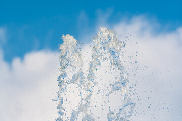 Splashes and jets of water against light background.
