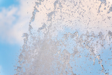Splashes and jets of water against light background.