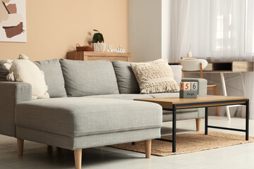 Interior of living room with sofa, workplace and countdown calendar on table