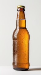 Bottle of chilled amber beer with condensation resting on a white surface in warm lighting