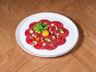 Beef Carpaccio with Raw Egg Yolk, Microgreens, and Gourmet Garnish