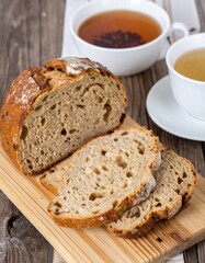Rustic Wooden Table with Freshly Baked Bread and Herbal Tea Scene
