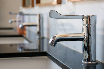 sleek chrome faucet installed on a polished black marble counter
