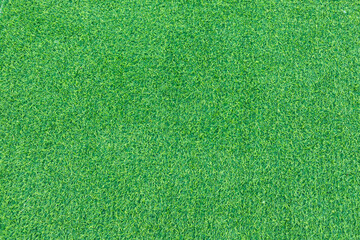Close-up of lush green artificial grass, showcasing its detailed texture and vibrant color, perfect...