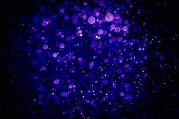 Blurred photo with purple violet and blue dots visible glittering, shining brightly look and feel luxurious