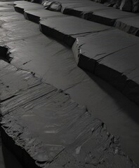Black textured concrete; deep crevices and shadows ,  weathered,  aged,  background
