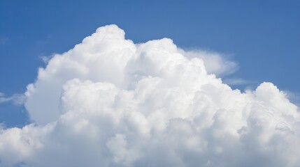 Fluffy white cloud in summer sky, peaceful and serene