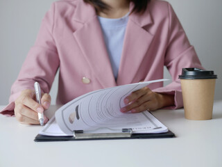 Businesswoman holding resume and interviewing new employee, evaluating, looking at applicant's...
