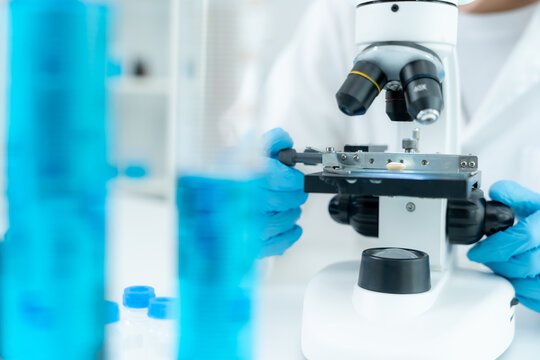 Scientist analyze biochemical samples in advanced scientific laboratory. Medical professional use microscope look microbiological developmental of viral. Biotechnology research in science lab.