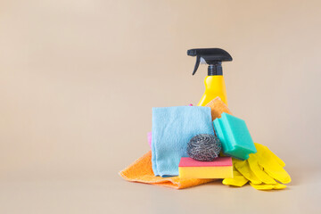 A set of various cleaning products, napkins and gloves to keep the house clean in close-up on a light background of kopi space
