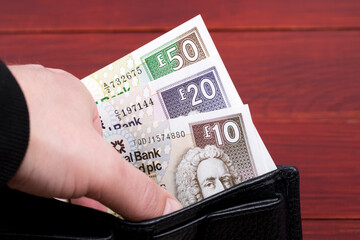 Scottish money - pounds in the black wallet
