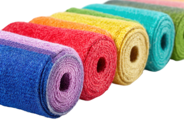 Colorful yarn rolls in a row displaying vibrant textile variety, cut out