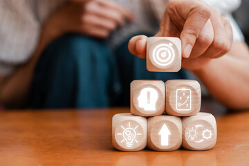Wooden blocks with icons symbolizing strategic planning, innovation, and business growth.