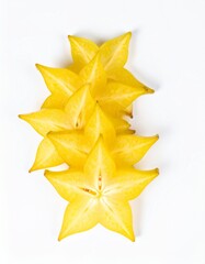 Fototapeta premium Sliced Starfruit Arranged in Fan Pattern with Cardamom Pods on Isolated White Background Composition