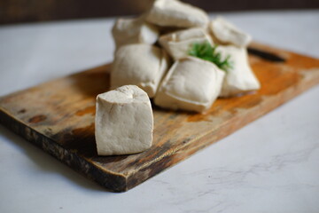 White tofu on wooden board 
