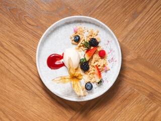 Chocolate mousse with caramelized banana, berries and vanilla ice cream on white plate