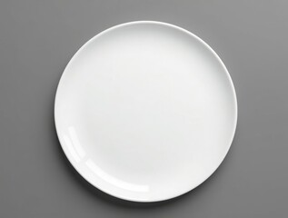 A clean shot of a simple white plate set against a monochrome background