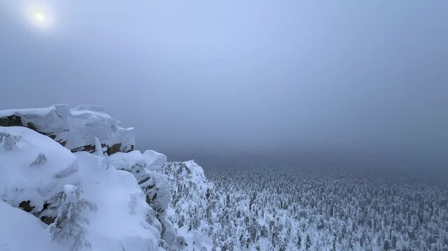 View of the white rocks and the winter forest on Mount Polyud. Lappish spruces on Mount Polyud in the Perm region in winter. In winter, there is a lot of snow and frost on the trees in the Urals. 4К